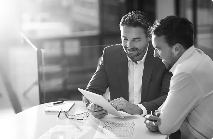 Two business men discussing financials.