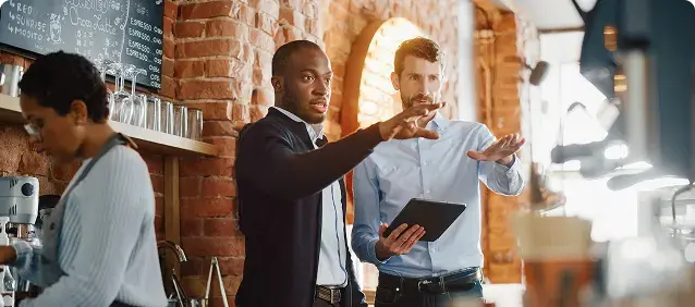 Colleagues discussing a document at work.
