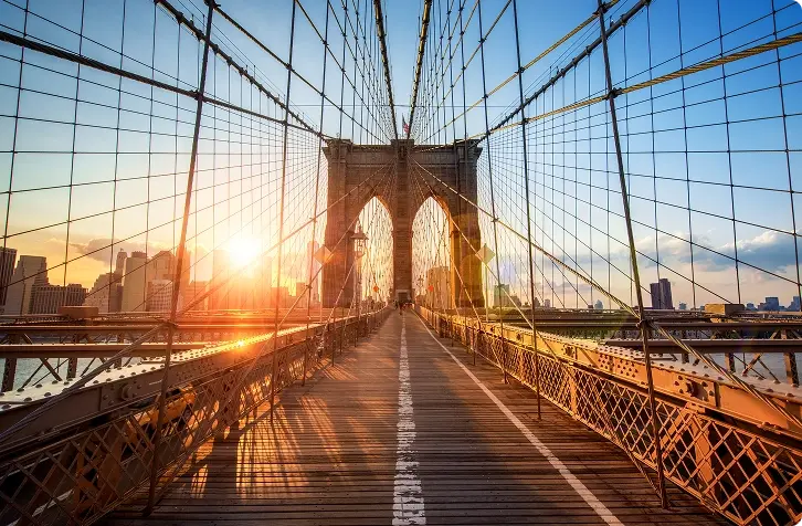Sunlight across the Brooklyn Bridge's pedestrian walkway.