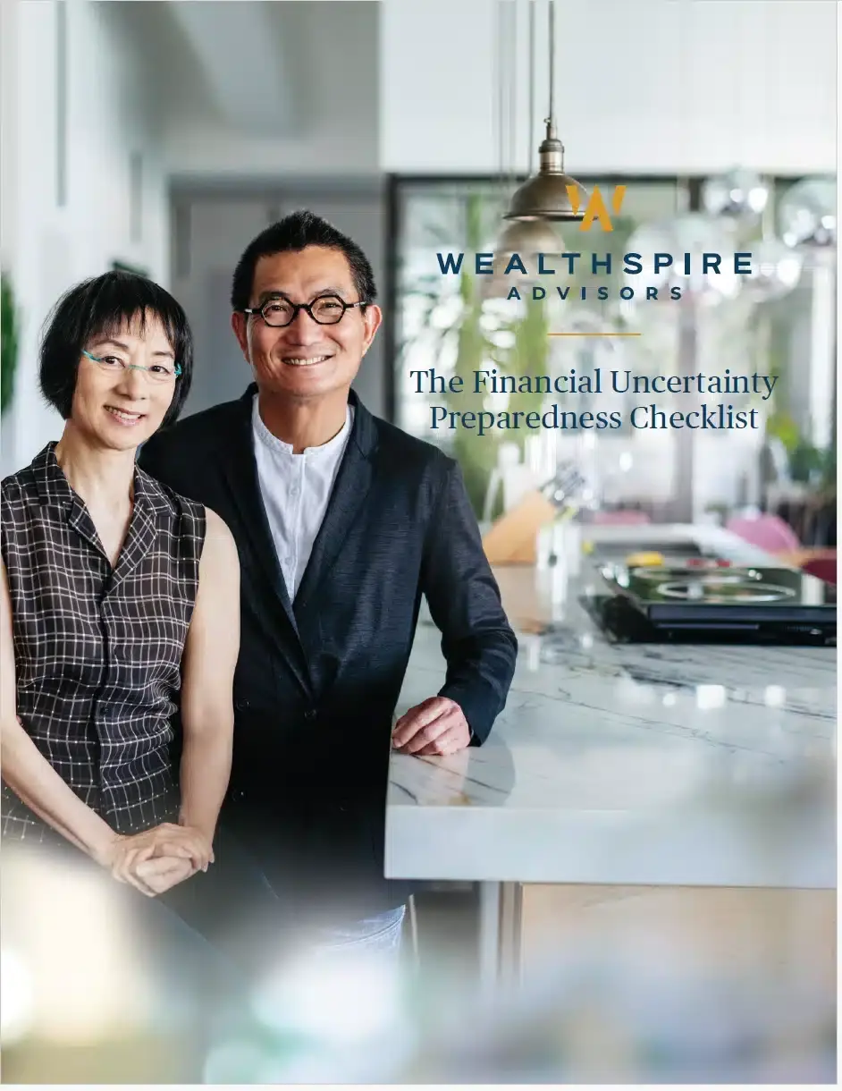 Two mature adults standing in a modern kitchen, smiling at camera.