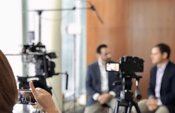 Men being interviewed on camera.